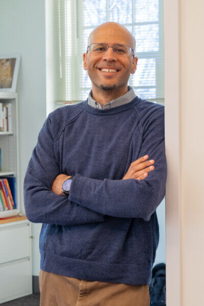 Anthony Burrow leans on the door outside his office