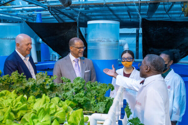 New York City Department of Education Chancellor David Banks speaks with Philson A.A. Warner, founding director of the Cornell Learning Labs, right, during a recent visit Banks made to Food and Finance High School.