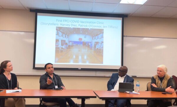 The Tree of Life Center partners at a table describing the partnership to an audience